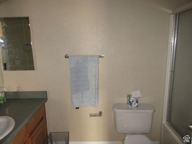 full bathroom featuring toilet, shower / bath combination with glass door, and vanity