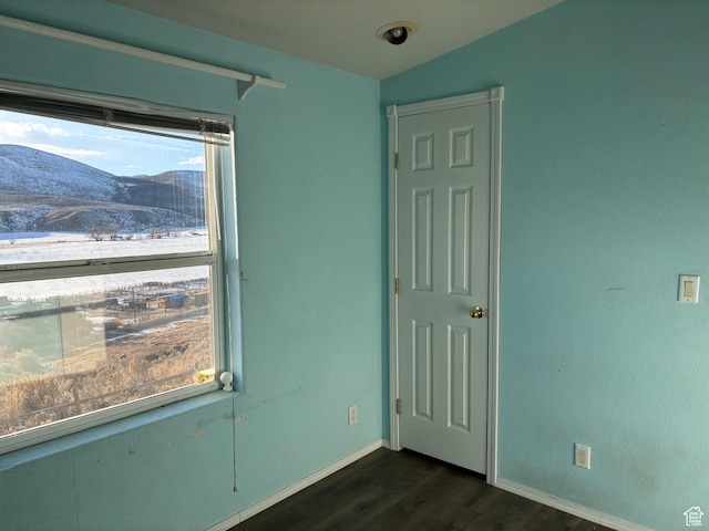 4981 N Daniels Rd, Malad City, ID 83252 - empty room featuring dark hardwood / wood-style flooring and a mountain view