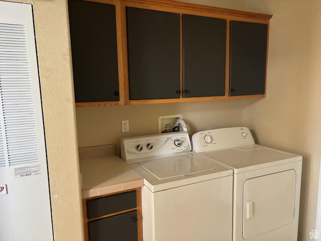 4981 N Daniels Rd, Malad City, ID 83252 - clothes washing area featuring cabinets and washing machine and dryer
