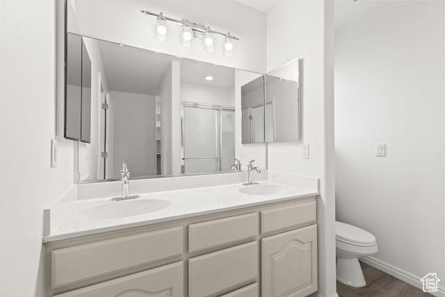 1305 E Riverside Dr Unit 1, St George, UT 84790 - full bath featuring toilet, a shower stall, double vanity, wood finished floors, and baseboards