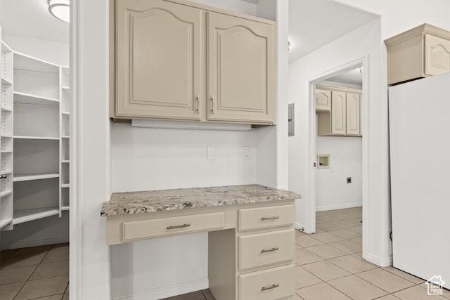 1305 E Riverside Dr Unit 1, St George, UT 84790 - kitchen with cream cabinets, light tile patterned floors, freestanding refrigerator, and light stone countertops