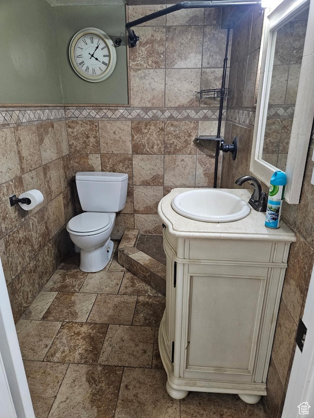 1060 E 30th S, Ogden, UT 84403 - bathroom featuring toilet, tile walls, vanity, and stone tile floors