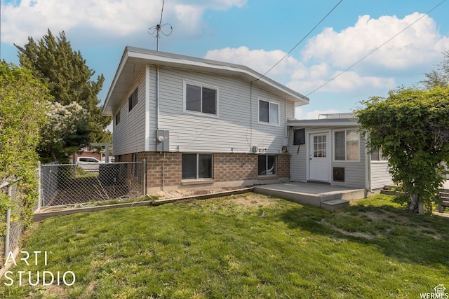 19 Sumac Way, Brigham City, UT 84302 - back of house featuring a patio area, a lawn, brick siding, and fence