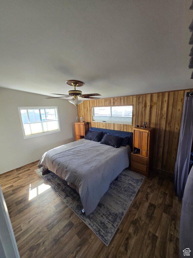 19 Sumac Way, Brigham City, UT 84302 - bedroom featuring a ceiling fan, wooden walls, and dark wood-style flooring