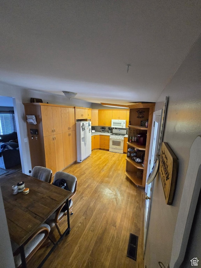 19 Sumac Way, Brigham City, UT 84302 - kitchen featuring visible vents, light wood-type flooring, open shelves, white appliances, and light countertops