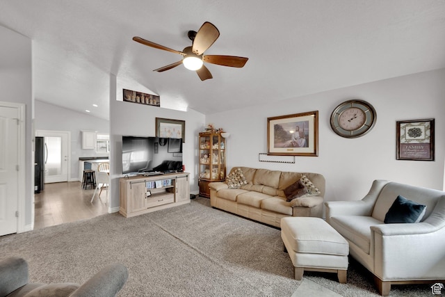 carpeted living room with lofted ceiling and ceiling fan