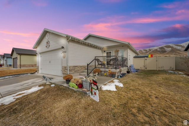 property exterior at dusk with a garage and a yard