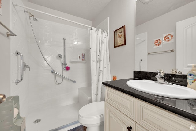 bathroom with toilet, a textured ceiling, a shower with curtain, and vanity