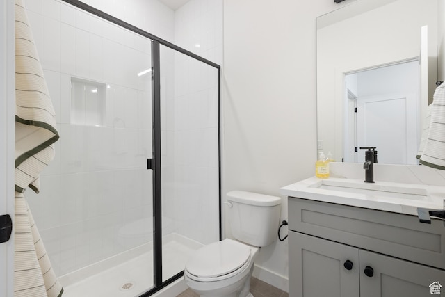 bathroom with vanity, an enclosed shower, and toilet