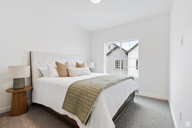 bedroom featuring dark carpet