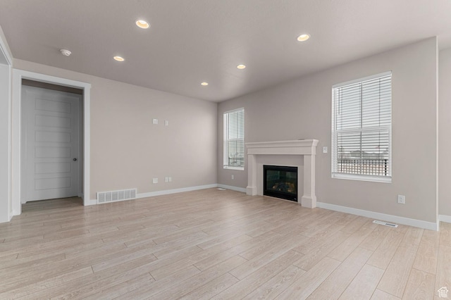 1282 E Clipper Peaks, Eagle Mountain, UT 84005 - unfurnished living room featuring light hardwood / wood-style floors