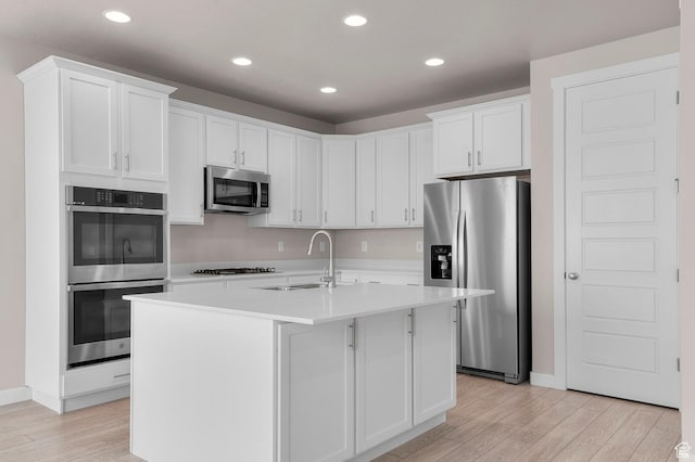 1282 E Clipper Peaks, Eagle Mountain, UT 84005 - kitchen with a center island with sink, light wood-type flooring, stainless steel appliances, white cabinets, and sink