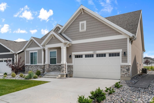 1282 E Clipper Peaks, Eagle Mountain, UT 84005 - craftsman-style house featuring a garage, concrete driveway, stone siding, and a shingled roof