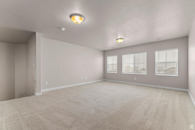 1282 E Clipper Peaks, Eagle Mountain, UT 84005 - spare room featuring light carpet and a textured ceiling