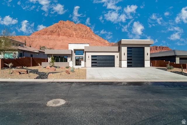 contemporary home featuring a mountain view and a garage