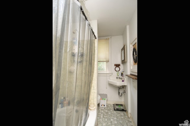 2424 S Jackson Ave E, Ogden, UT 84401 - bathroom featuring shower / tub combo with curtain and toilet