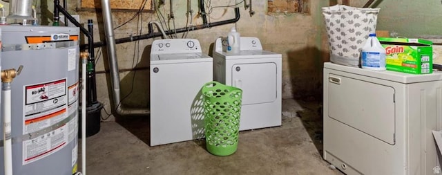 clothes washing area with water heater, laundry area, and washer and clothes dryer