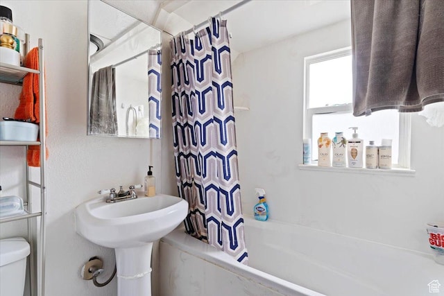 full bathroom featuring shower / bath combination with curtain and toilet