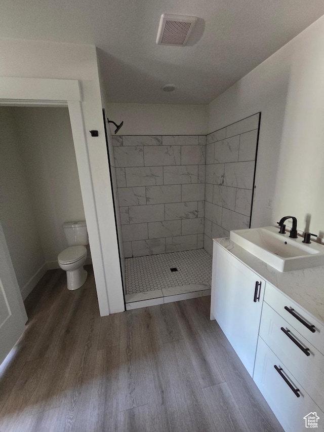 640 S 1030 E, Smithfield, UT 84335 - full bathroom featuring wood finished floors, a stall shower, toilet, and vanity