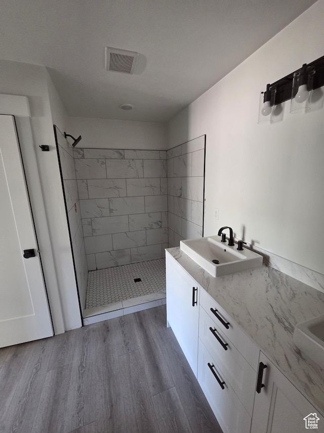 640 S 1030 E, Smithfield, UT 84335 - full bath with double vanity, a shower stall, and wood finished floors