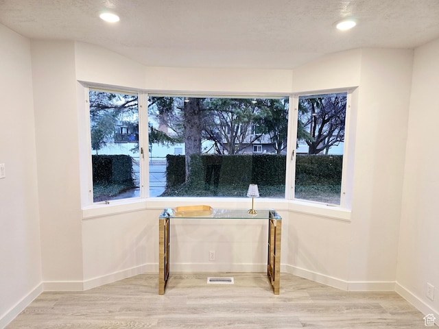 interior space with recessed lighting, wood finished floors, visible vents, and baseboards
