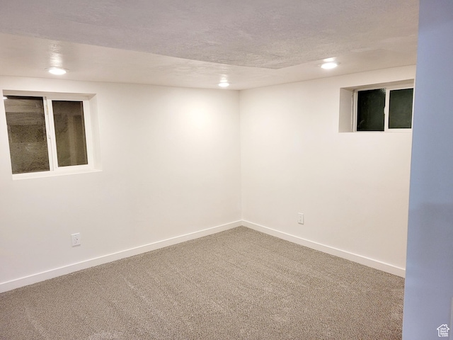 unfurnished room featuring a textured ceiling, baseboards, carpet flooring, and recessed lighting
