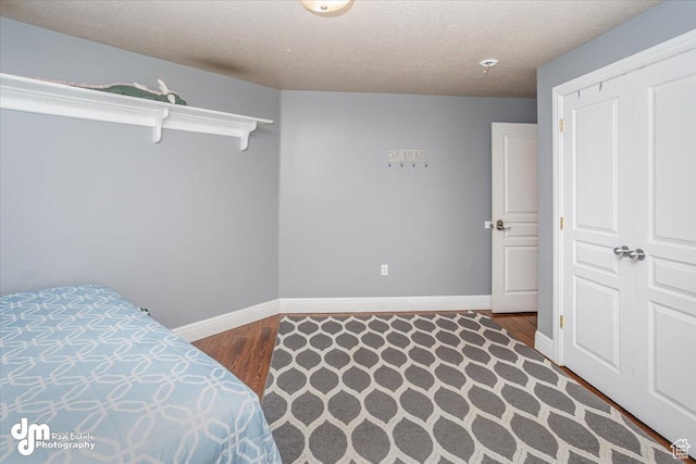 bedroom featuring wood-type flooring and a textured ceiling