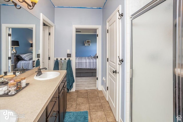 bathroom with tile patterned flooring, an enclosed shower, and vanity
