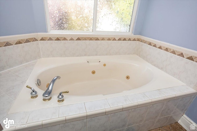 bathroom featuring a relaxing tiled tub