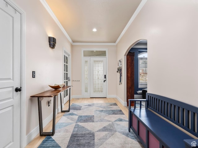 entryway featuring light hardwood / wood-style floors and crown molding