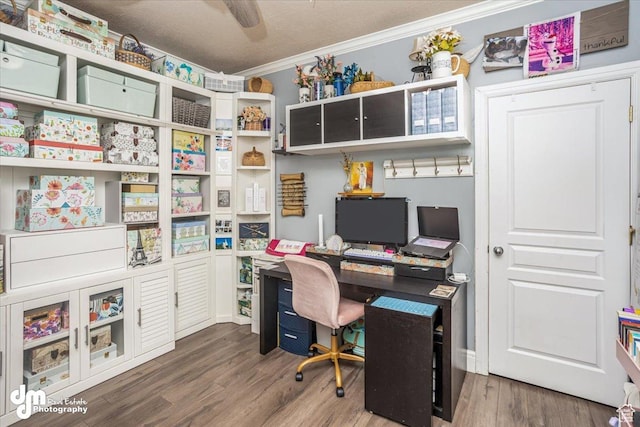 office space with ornamental molding, dark wood-type flooring, and a textured ceiling