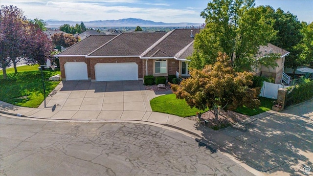 ranch-style house featuring a mountain view and a garage
