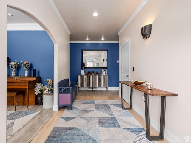 hallway featuring ornamental molding and light hardwood / wood-style flooring