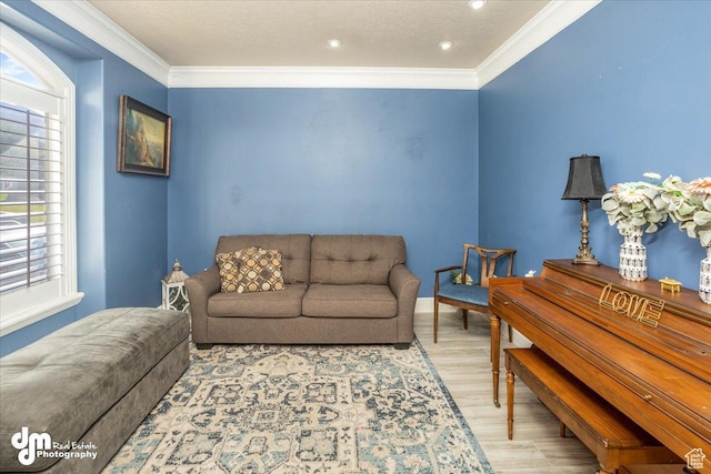 living room with light wood-type flooring and ornamental molding