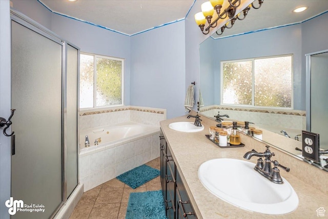 bathroom featuring a notable chandelier, tile patterned flooring, vanity, and separate shower and tub
