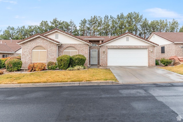 single story home with a front yard and a garage