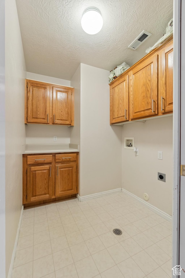 1040 S 1100 E Unit 85, St George, UT 84790 - clothes washing area with cabinets, hookup for an electric dryer, hookup for a gas dryer, a textured ceiling, and washer hookup
