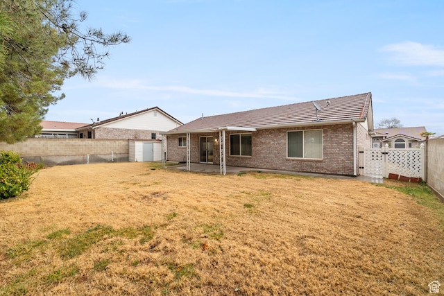 1040 S 1100 E Unit 85, St George, UT 84790 - rear view of house featuring a yard, a patio area, and a shed