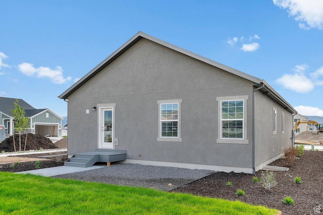back of property featuring stucco siding