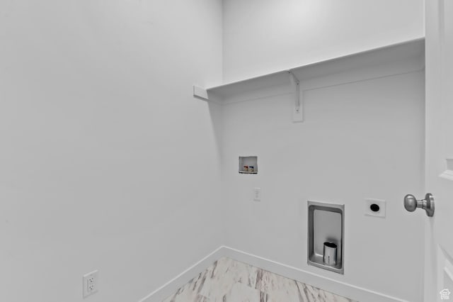 laundry area featuring hookup for a washing machine, baseboards, and light marble finish flooring
