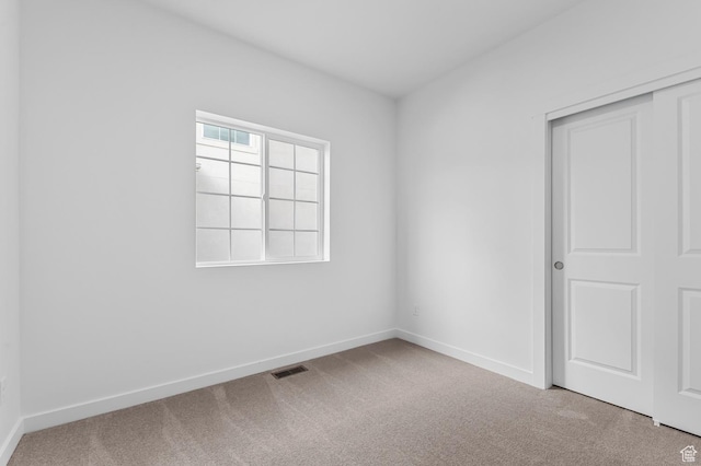 empty room with carpet floors and baseboards