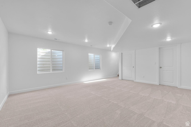 unfurnished room with light carpet, baseboards, and recessed lighting