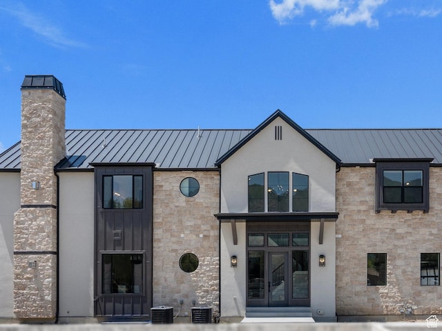 view of front of property with central AC unit and french doors