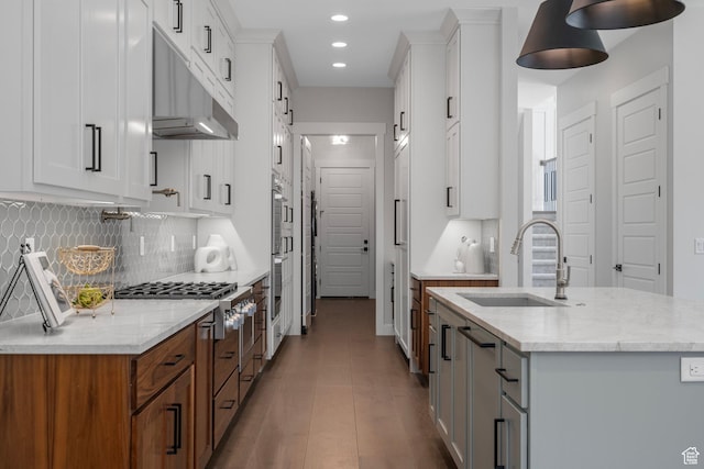 250 S Main St Unit 7, Alpine, UT 84004 - kitchen featuring sink, light stone counters, white cabinetry, a kitchen island with sink, and decorative backsplash