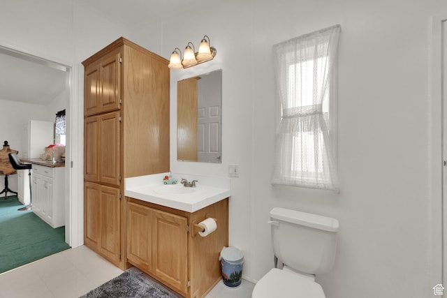 bathroom featuring toilet, vanity, and tile patterned floors