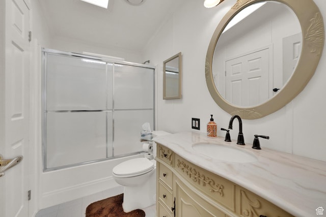 full bathroom with bath / shower combo with glass door, tile patterned flooring, vanity, and toilet