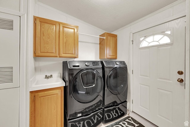 laundry room with cabinet space, ornamental molding, a textured ceiling, separate washer and dryer, and a heating unit