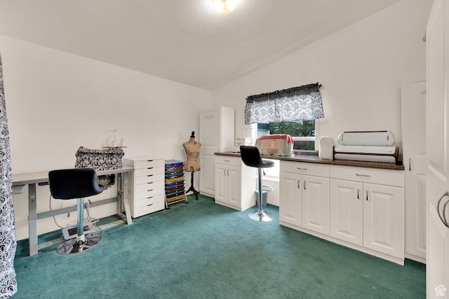 carpeted home office with vaulted ceiling