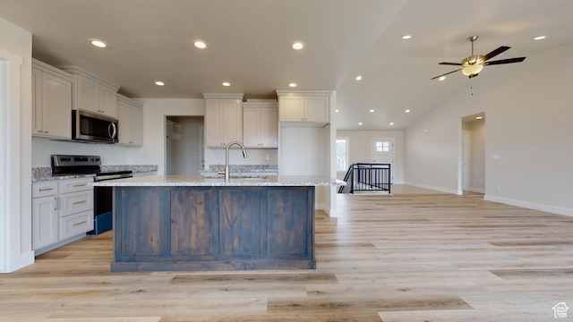 9270 N 5600 W Unit 7, Elwood, UT 84337 - kitchen with recessed lighting, light wood-style flooring, appliances with stainless steel finishes, a sink, and an island with sink