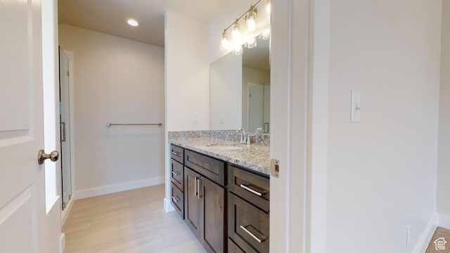 9270 N 5600 W Unit 7, Elwood, UT 84337 - full bathroom featuring recessed lighting, a shower with shower door, vanity, and baseboards